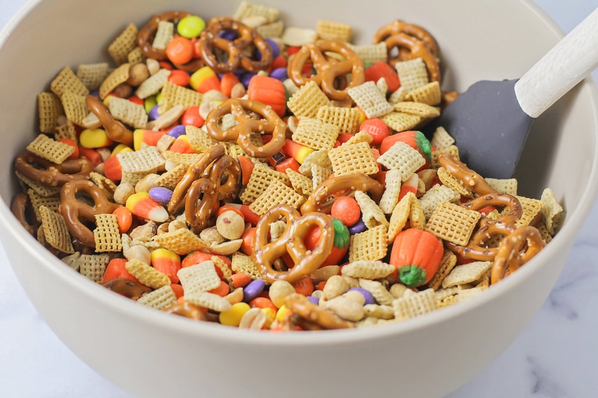 Combining cereal and candy in a bowl.