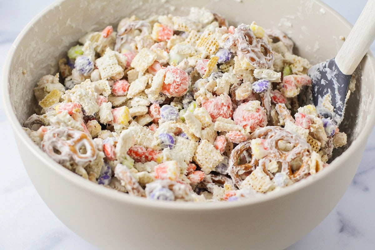 Coating the cereal mixture with candy coating.