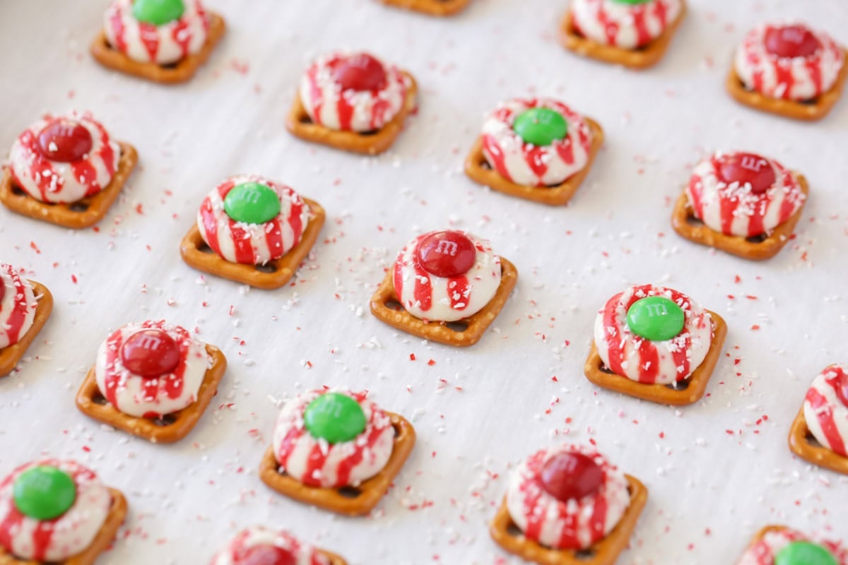 Holiday pretzel bites on a parchment lined baking sheet.