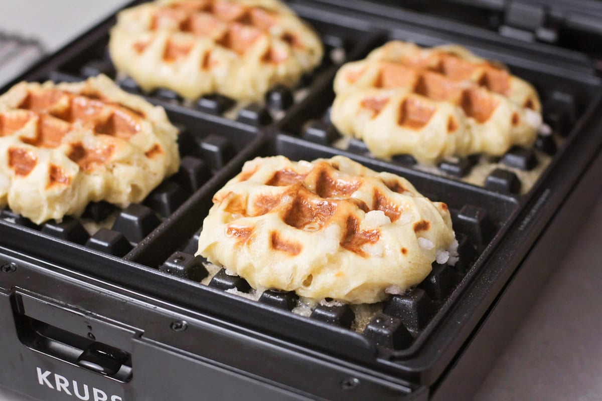 Cooked waffles in a waffle iron.