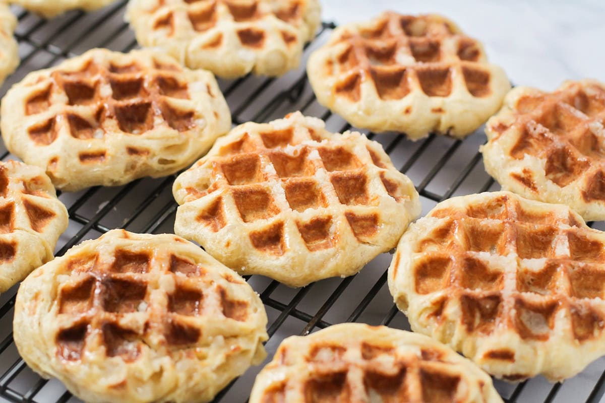 Several liege waffles on a cooling rack.