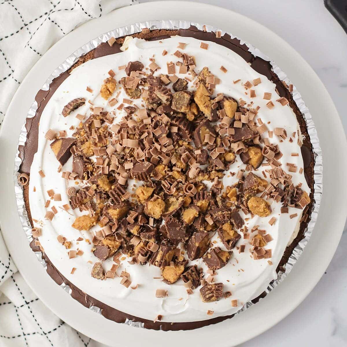 Top view of a peanut butter pie topped with Reese's.