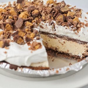 A peanut butter pie with a slice missing.