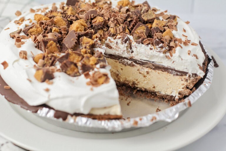 A peanut butter pie with a slice missing.