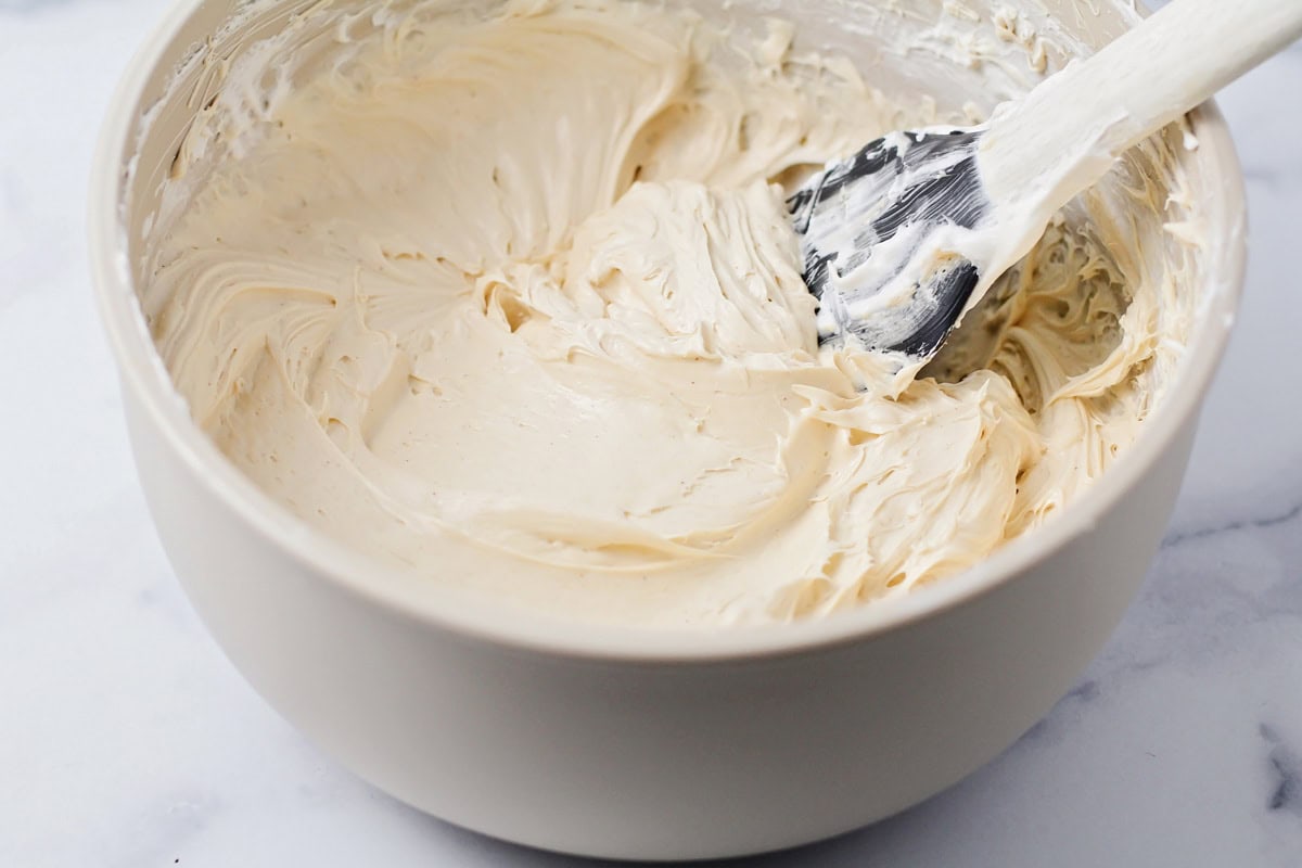 Mixing a creamy peanut butter filling in a bowl.