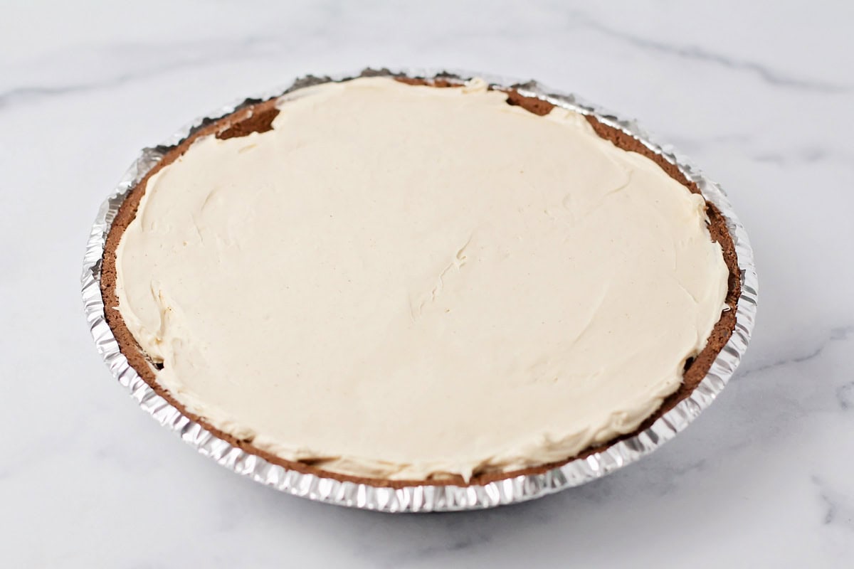 Peanut butter filling spread in a pie crust.