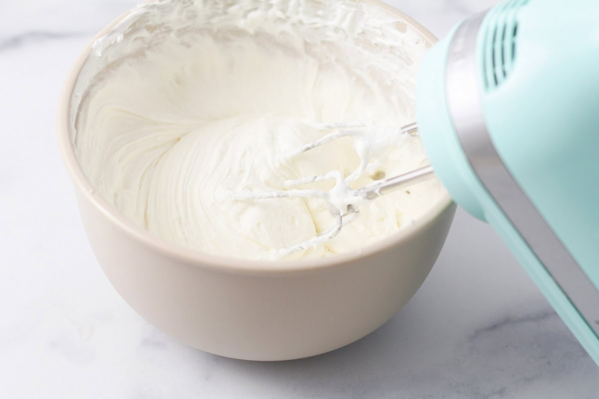 Cream cheese whipping by a hand mixer.