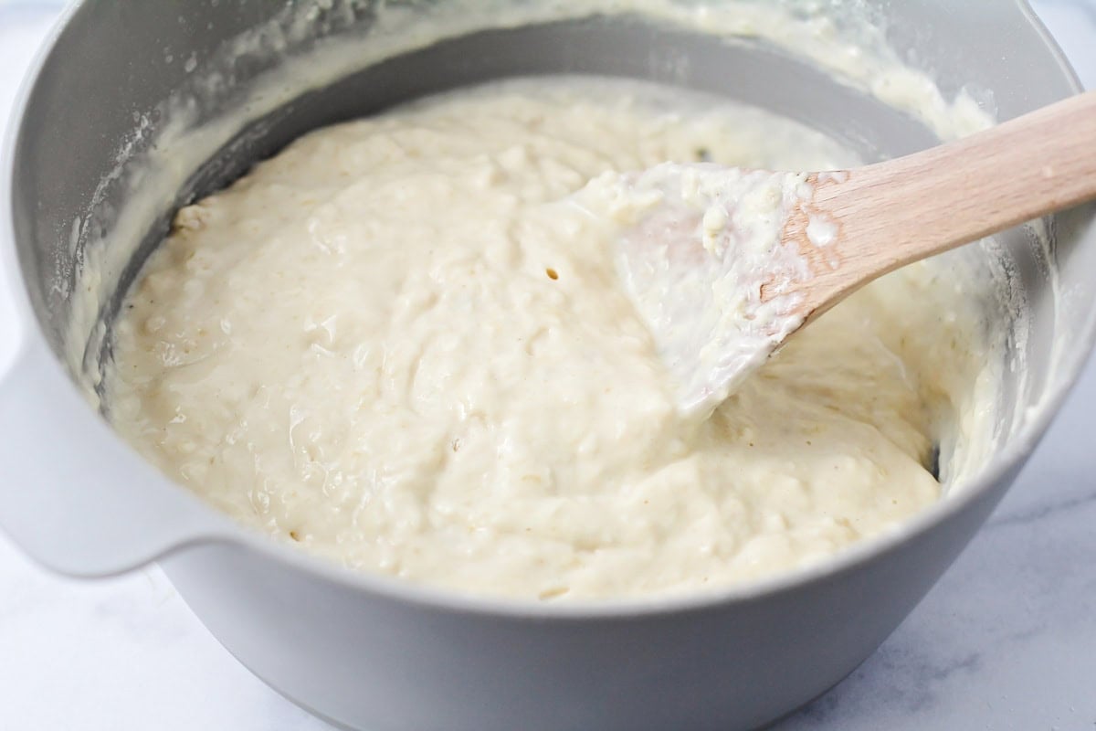 Mixing pancake batter in a gray bowl.