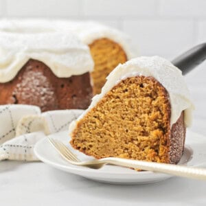 Pumpkin Bundt Cake slice removed and placed on a plate with a fork.