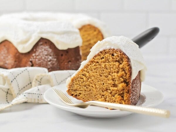 Pumpkin Bundt Cake slice removed and placed on a plate with a fork.