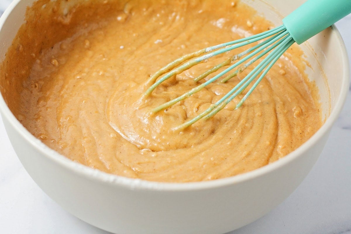 Pumpkin batter being mixed in a bowl.