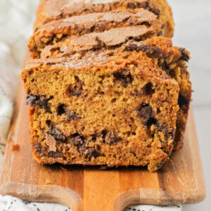 Sliced chocolate chip pumpkin bread on a cutting board.