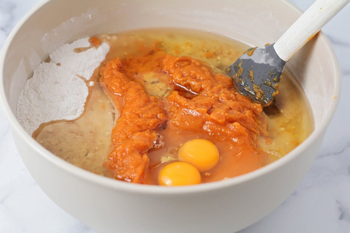 Pumpkin puree and other ingredients in a mixing bowl.