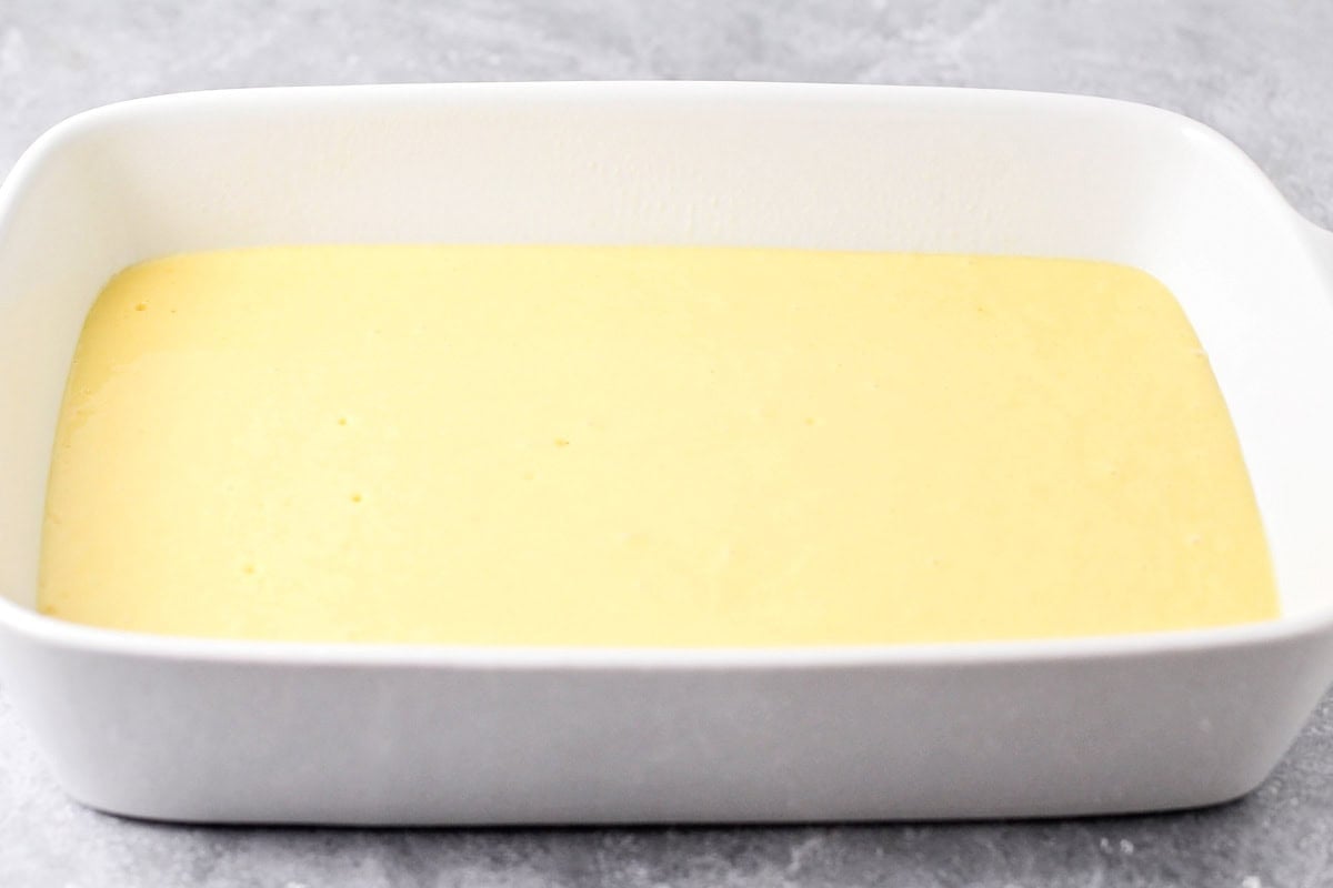 Cake batter in a white baking dish.