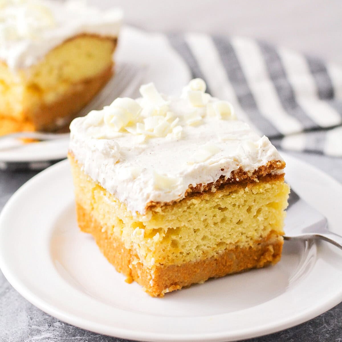 Magic pumpkin cake slice on white plate with fork.