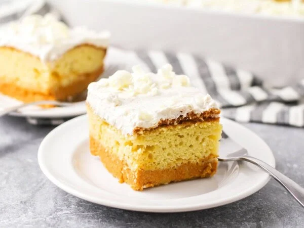 Pumpkin Magic Cake slice on white plate showing the layers of the cake.