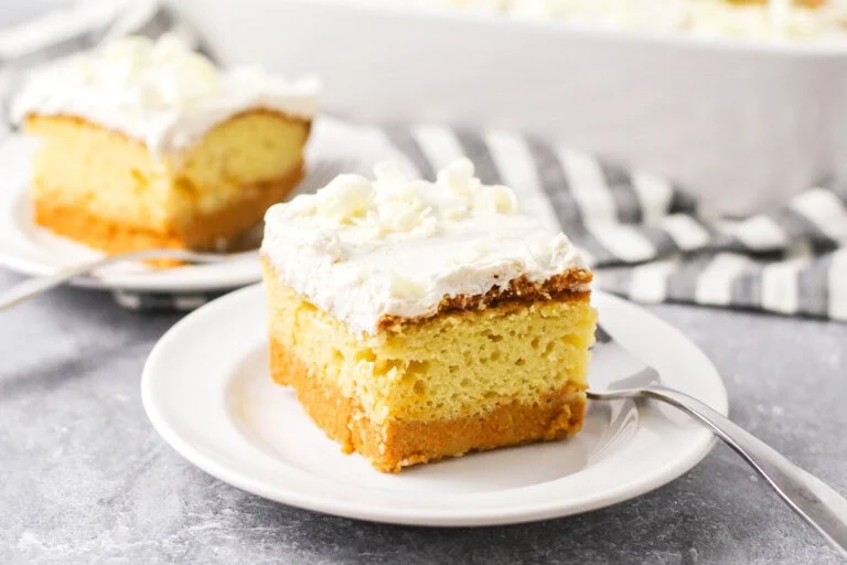 Pumpkin Magic Cake slice on white plate showing the layers of the cake.