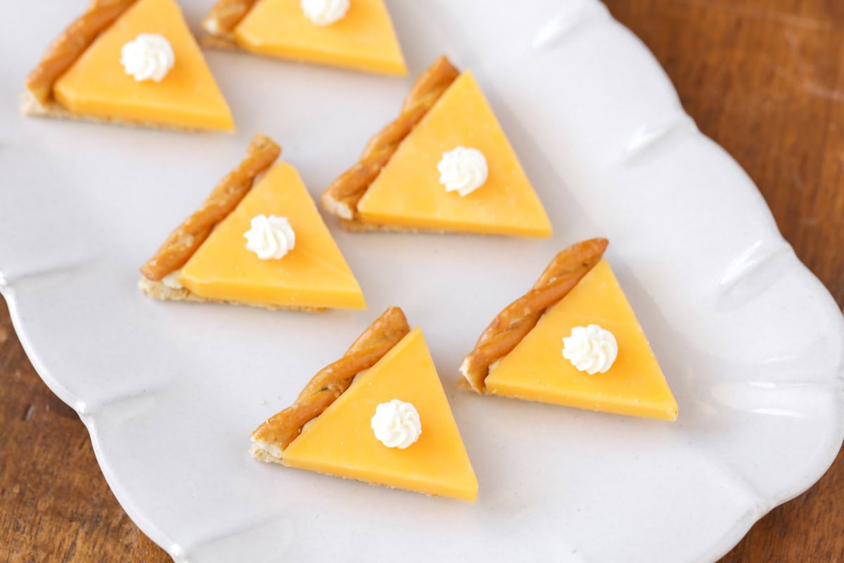 Pumpkin pie crackers on a white platter.