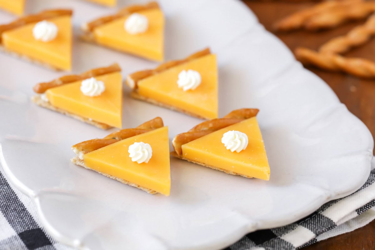 Several pumpkin pie crackers on top of a white platter.