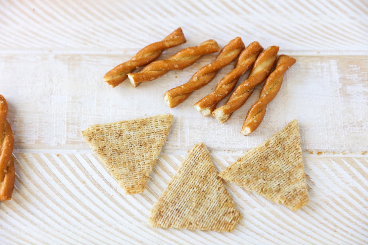 Triscuts and pretzels on a table.