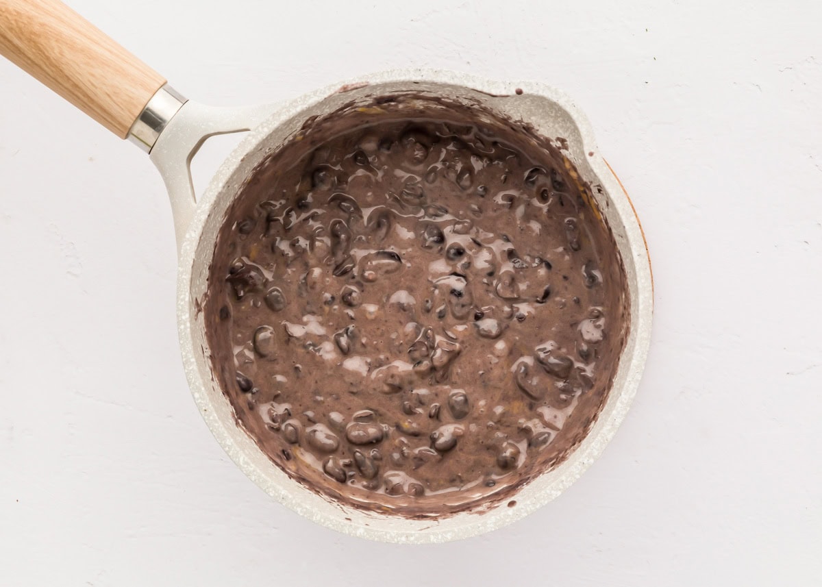 Black beans and seasonings mixed in a pot.