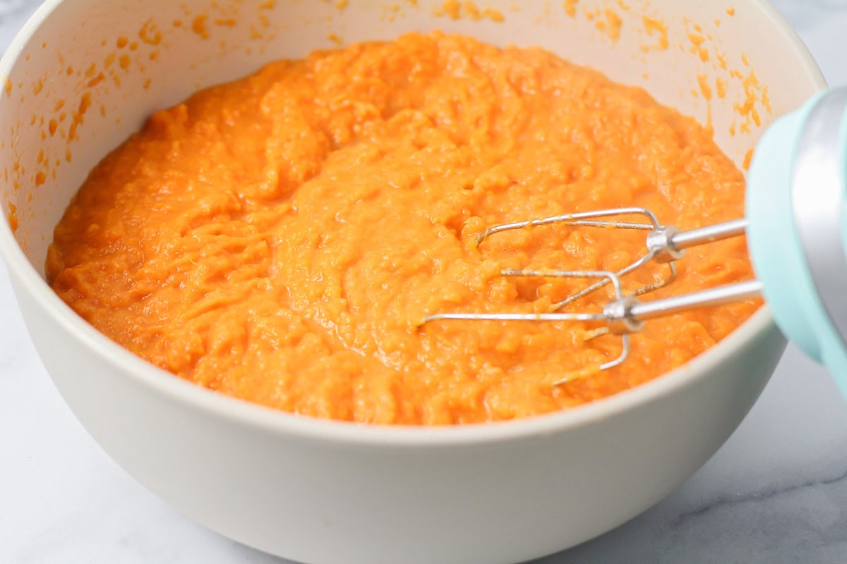 Creamed sweet potatoes in a white bowl.