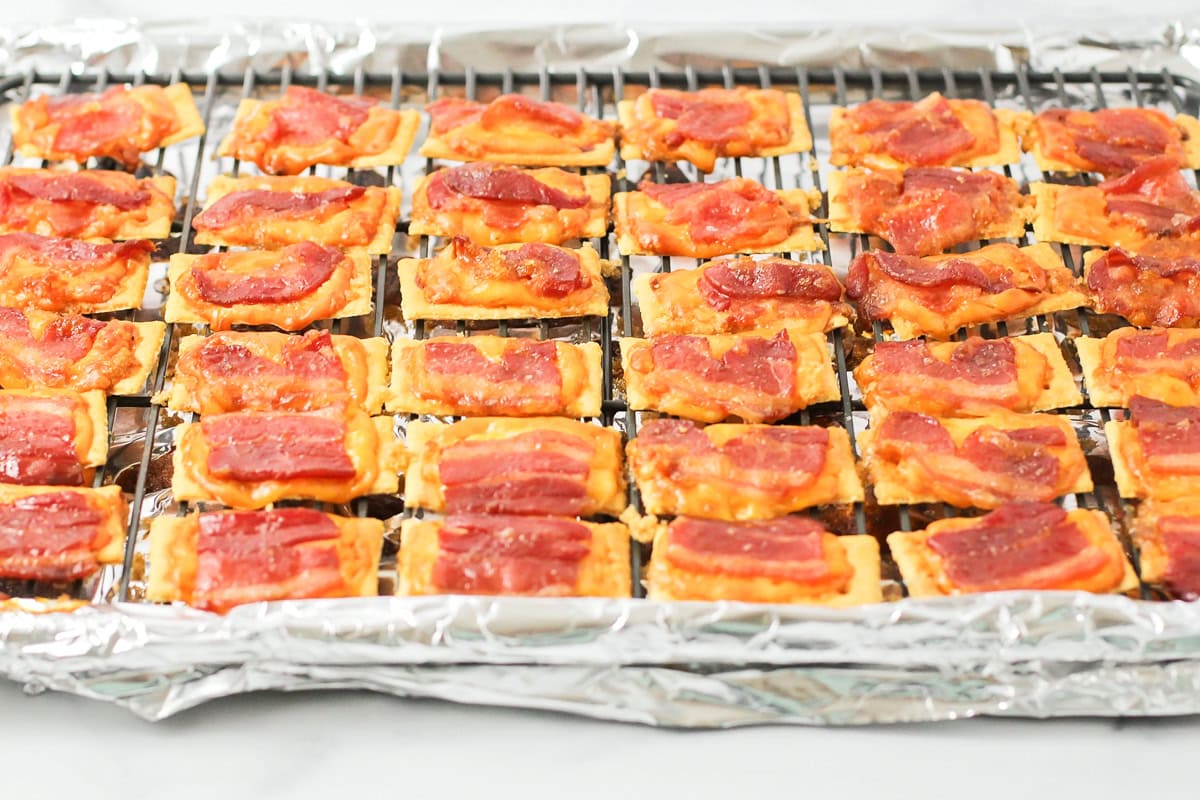 Close up of bacon crackers on a lined baking sheet.