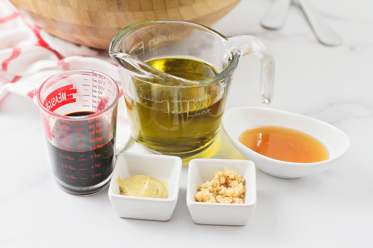 Ingredients for balsamic vinaigrette on a kitchen counter.