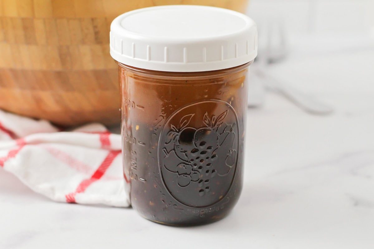 Shaking dressing in a mason jar.