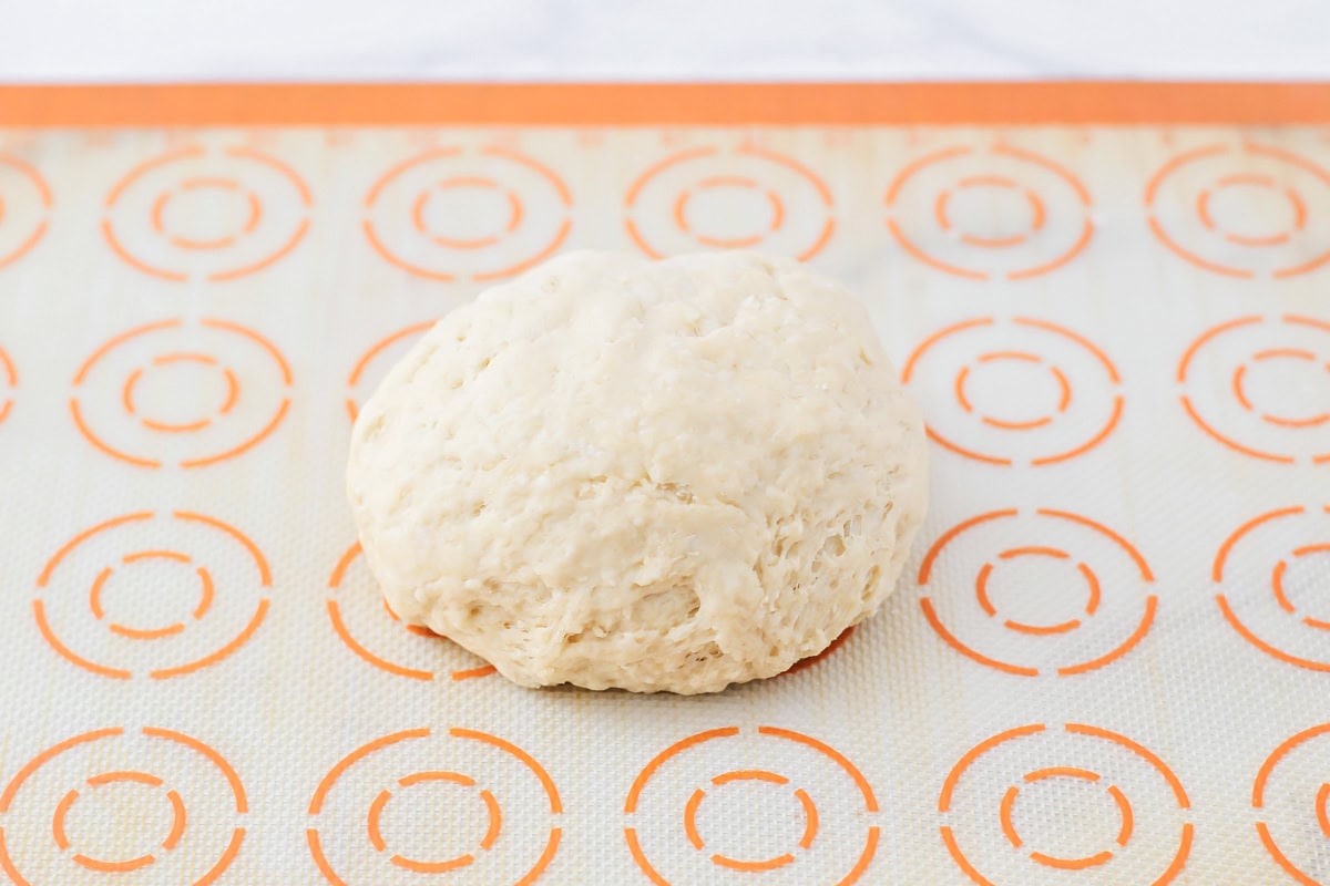 A ball of dough on a silpat mat.