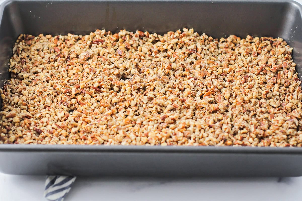 Chopped pecans in a baking dish.