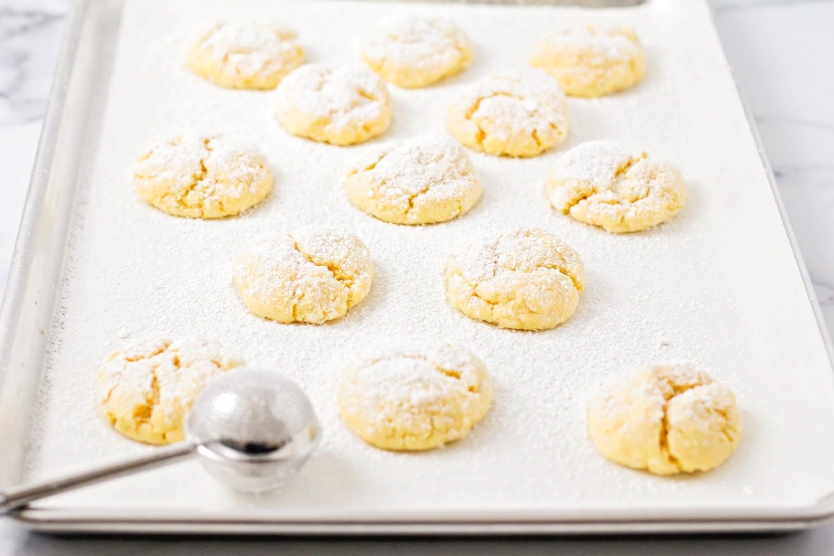 Sprinkling dough ball with powder sugar.