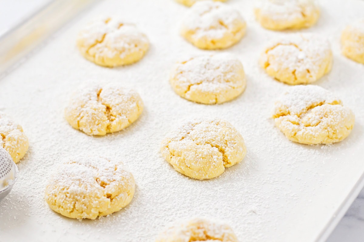 Baked cookies on a lined cookie sheet.