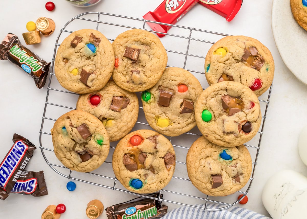 Candy cookies on cookie wrack with candy sprinkled all around.