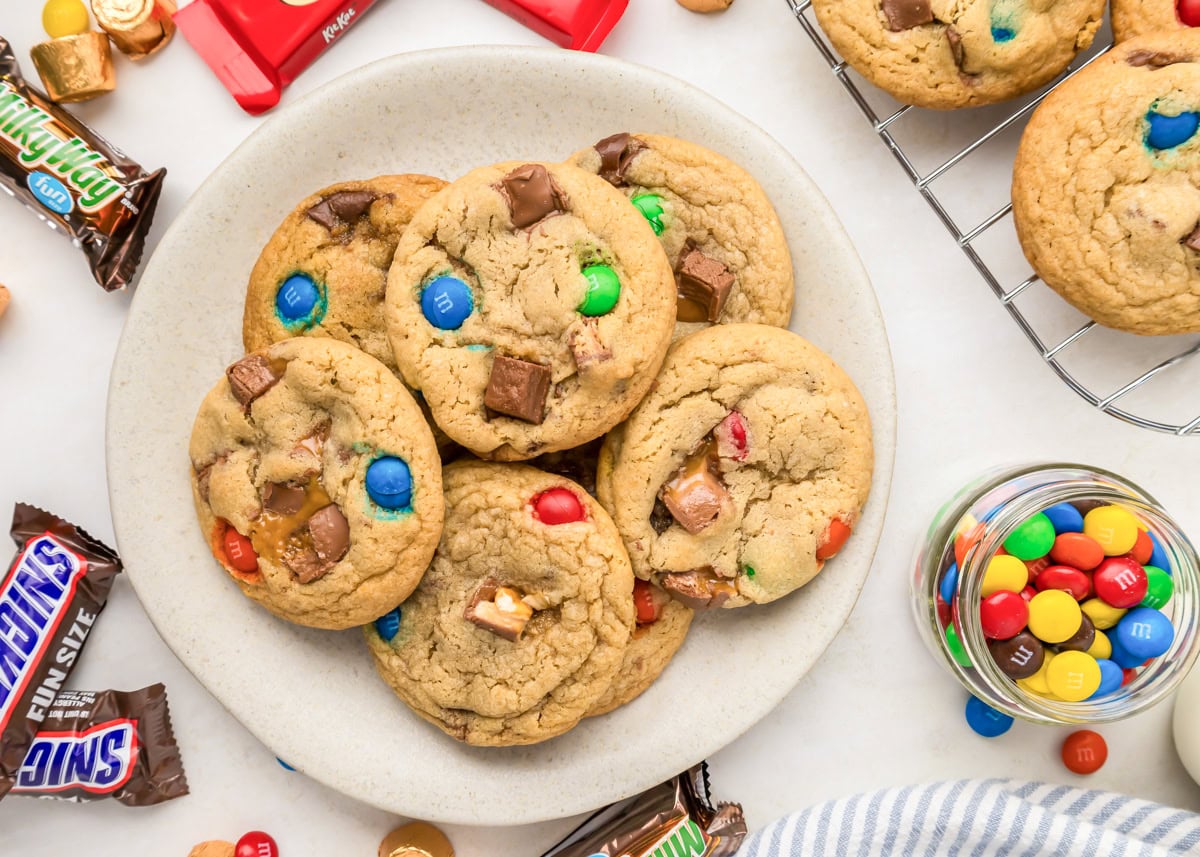 Candy cookies on plate with candy sprinkled all around.