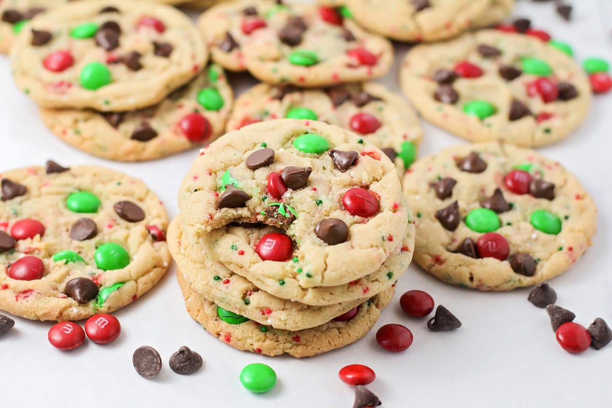 Close up of several Christmas chocolate chip cookies on a counter.