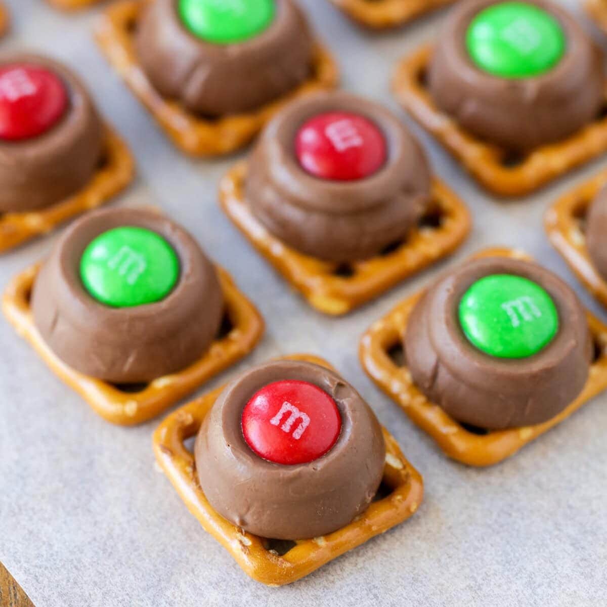 Christmas Rolo pretzels on a lined baking sheet.