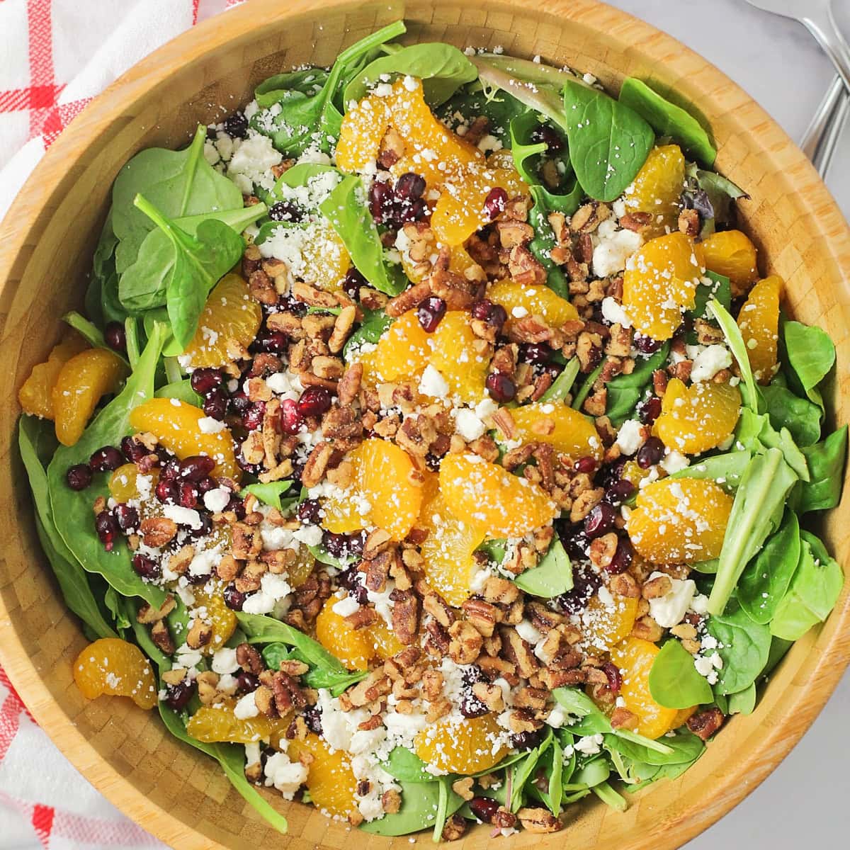 A wooden bowl filled with Christmas salad.