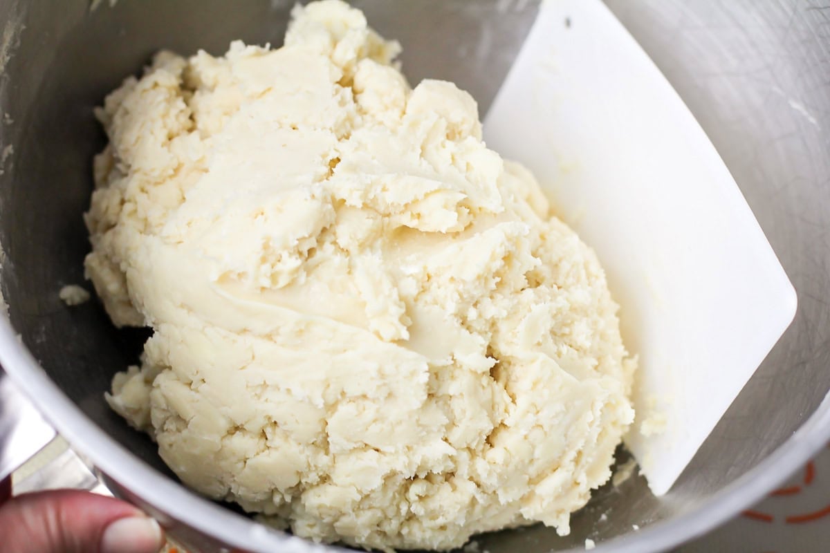 Sugar cookie dough in a metal bowl.