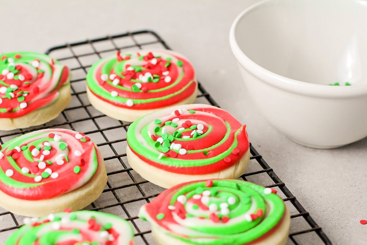 Circle cookies topped with green and red swirl frosting.