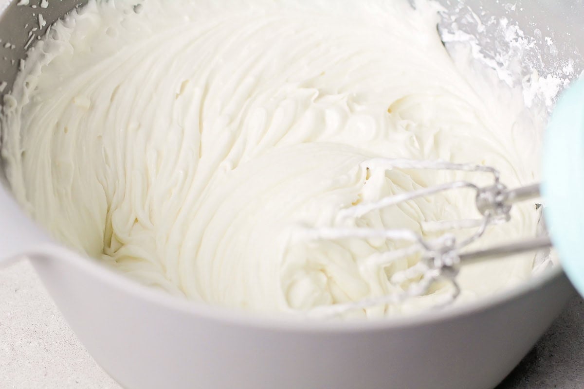 Whipping frosting in a gray bowl.