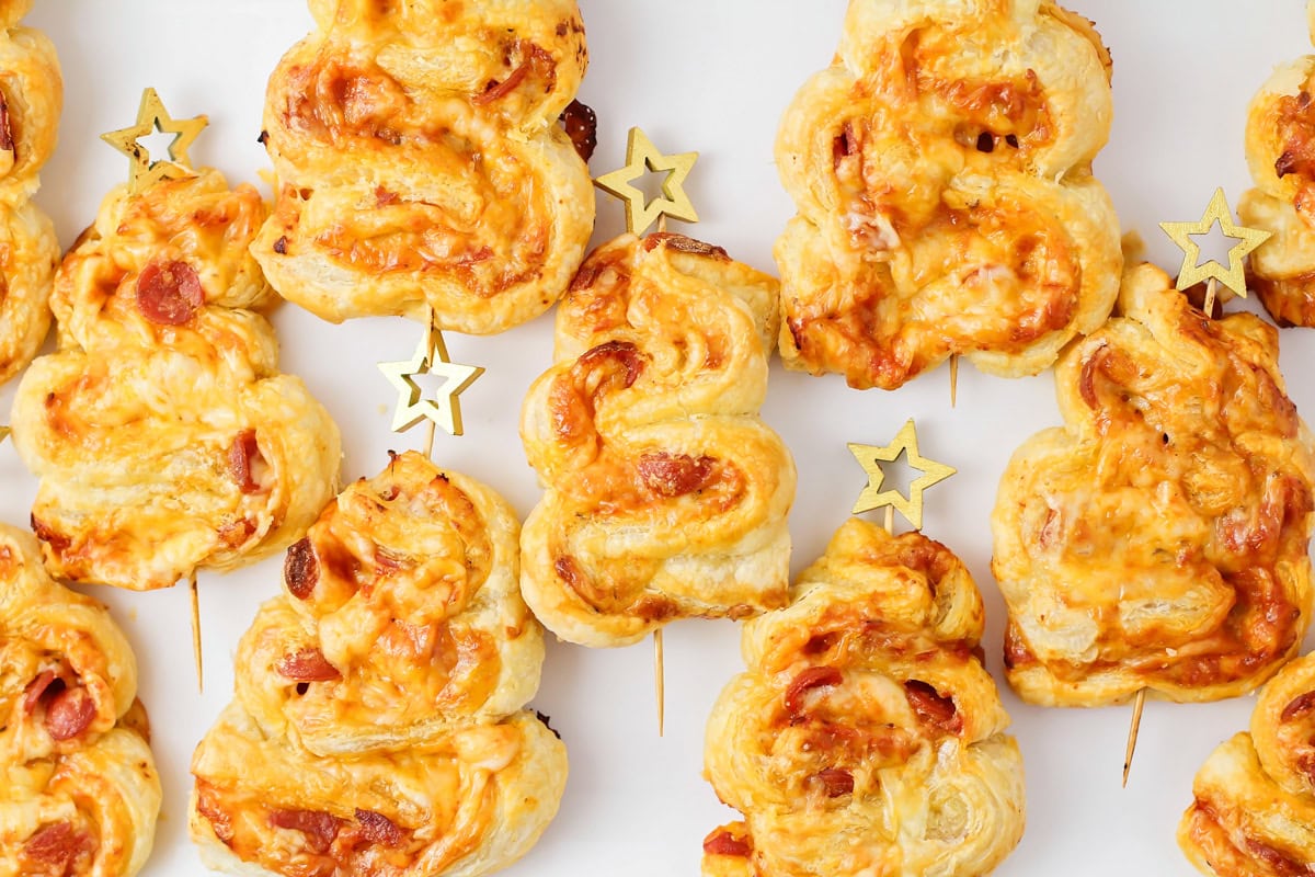 Several pepperoni Christmas tree appetizer on a kitchen counter.