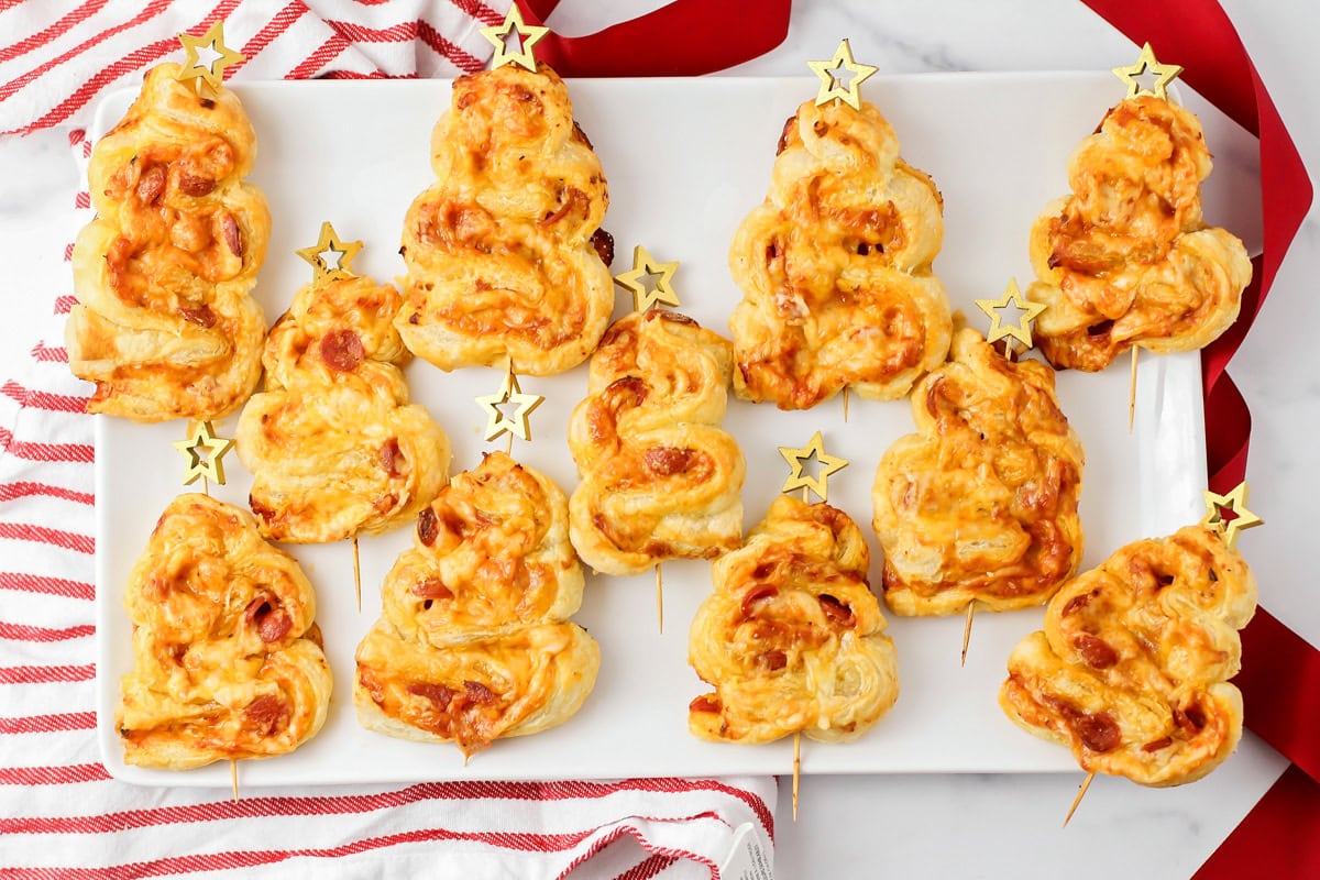 A platter of pepperoni Christmas tree appetizers with star skewers.