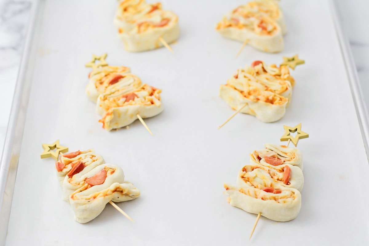 Shaping the puff pastry strips into Christmas trees.