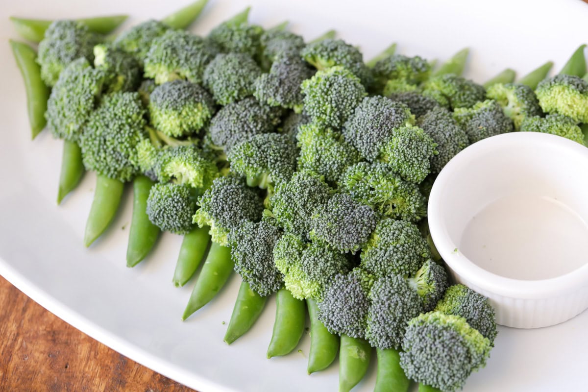 Filling the tree shape in with broccoli on the platter.