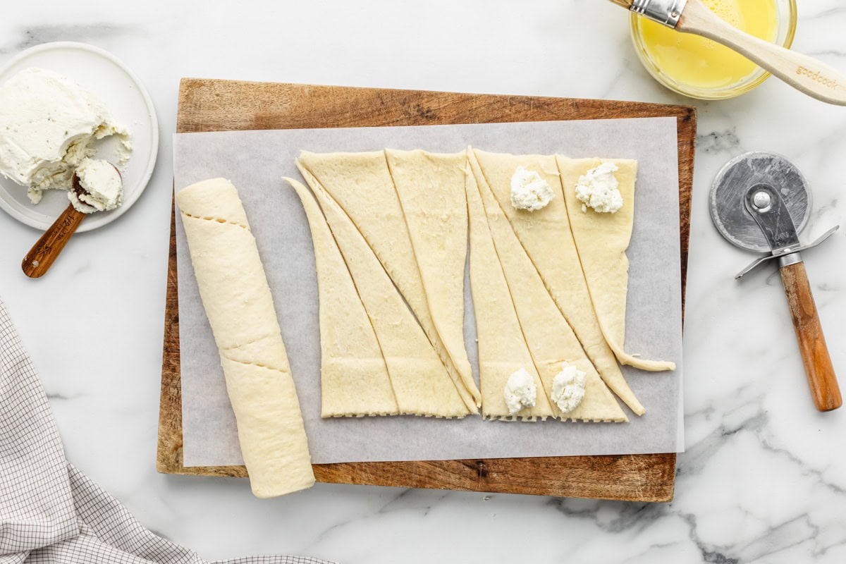 Adding a scoop of Boursin cheese to the center of the crescent roll triangles.