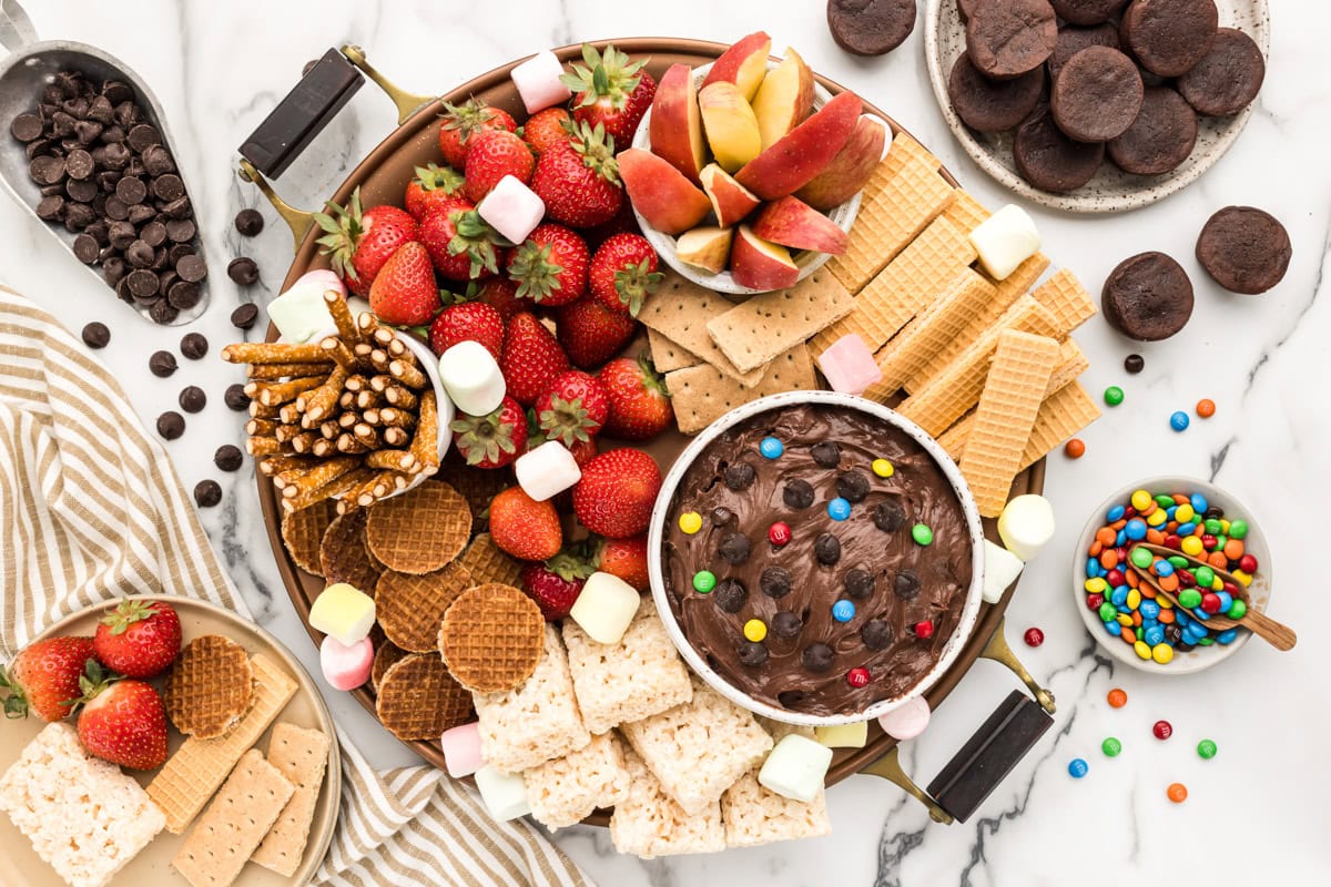 A dessert charcuterie board filled with finger food treats and desserts.