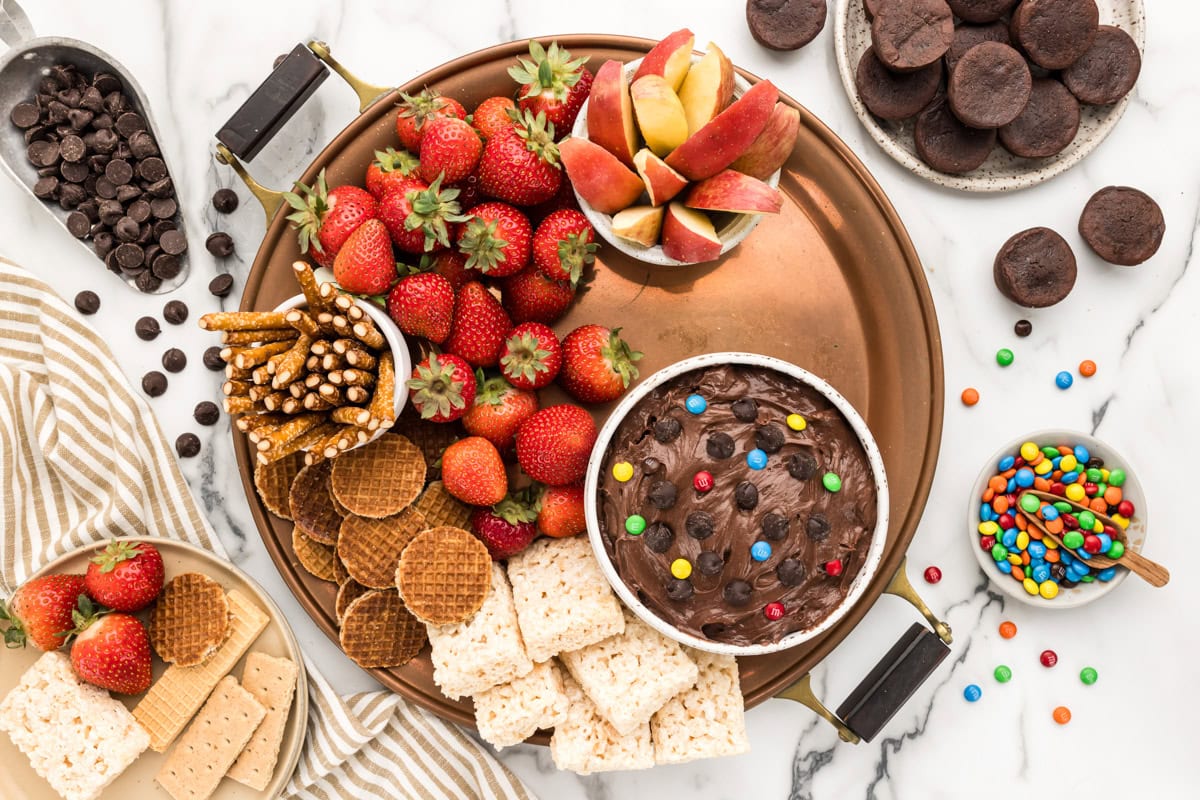 Filling the dessert charcuterie tray with stroopwaffles.