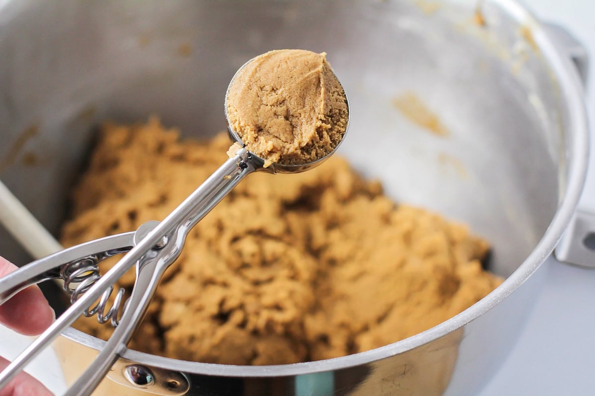 Scooping cookie dough with a cookie scoop.