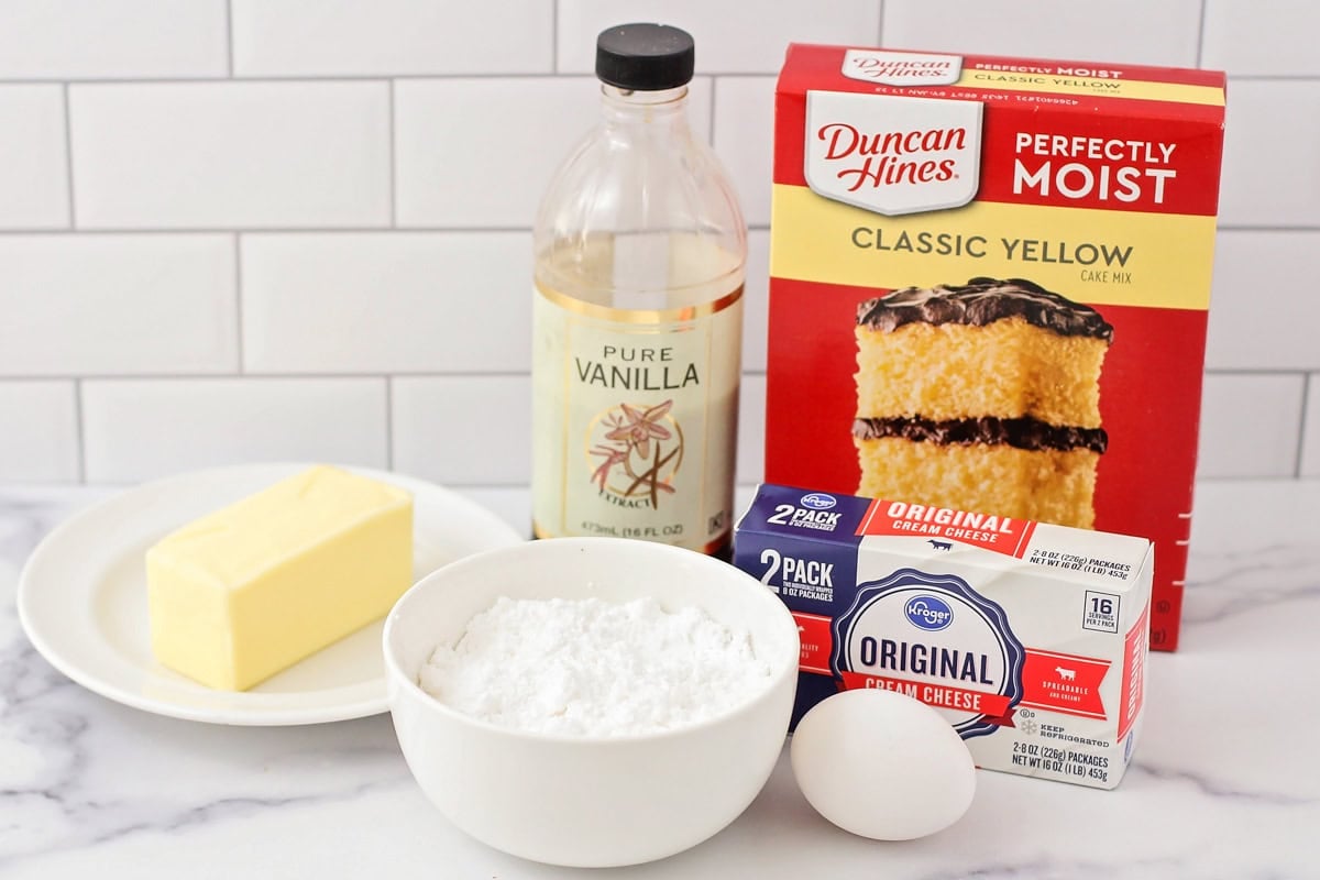 Ingredients for gooey butter cookies on white counter.